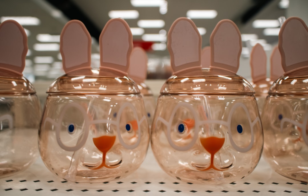 A close-up of Easter-themed bunny-shaped tumblers at Target. by Vitamin Brands Easter bunny-shaped jars are lined up in a store.
