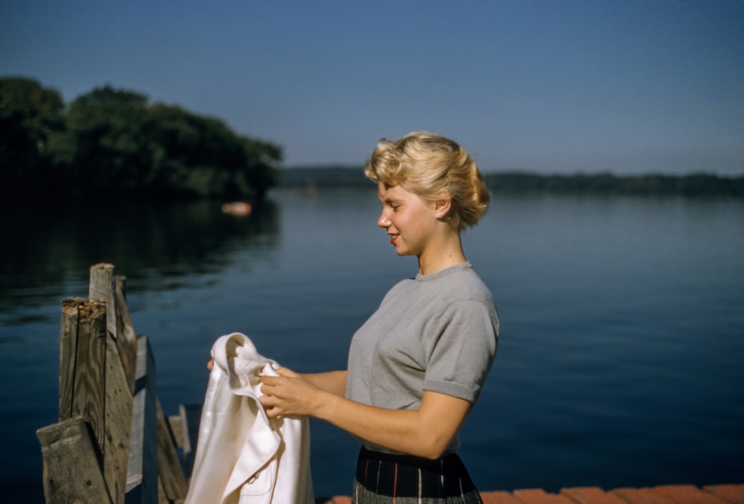 Vintage Hair by Vitamin Brands woman holding white textile standing beside body of water
